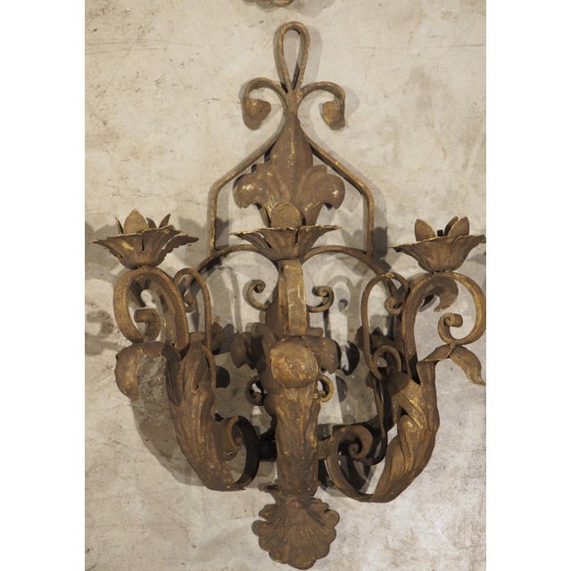 More information coming soon… A set of four French sconces in iron, detailed with tole leaves with a distressed gilt...