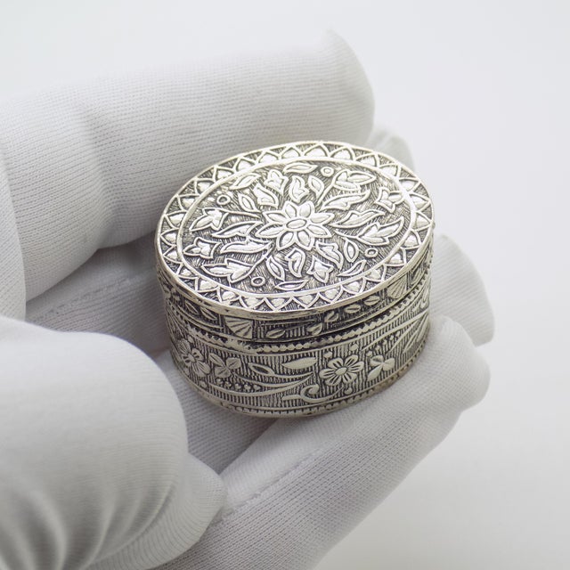 Characterized by its graceful oval geometry and generous depth, this vintage silver trinket box offers a refined...