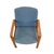 A handsome late 20th century Scandinavian Modern armchair pairing a warm teak frame with textured blue upholstery. The...