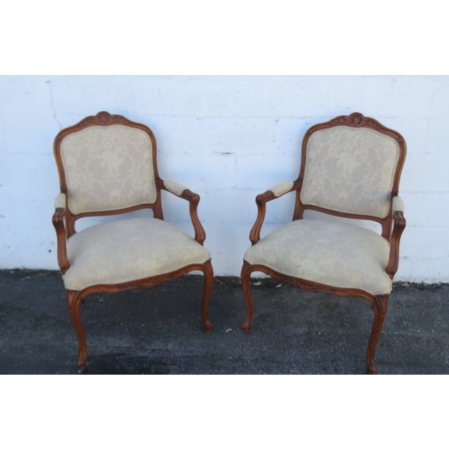 This charming Pair of Chairs is made of wood, solid wood, and upholstery. The Chairs are labeled that they were made by...