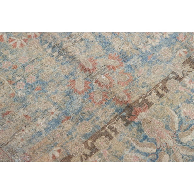 Beautiful Antique Sarouk hand-knotted wool rug with a blue color field. This Persian rug has a Classic floral design in...