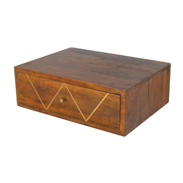 A floating storage piece made from solid mango wood with a warm chestnut finish. It features a brass-inlaid drawer and...