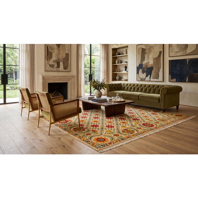 Elevate your interior with this exceptional hand-knotted wool area rug, seamlessly blending traditional Suzani-inspired...