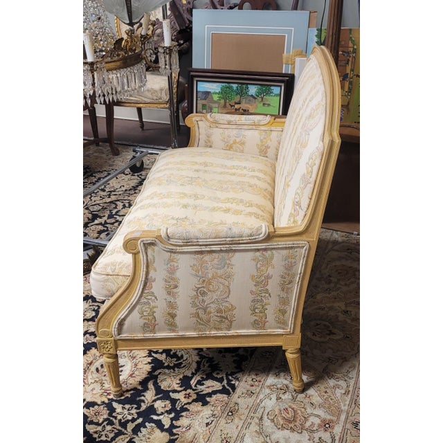 Beautiful French Empire Style small settee. Features a fruit wood frame in egg yolk stain, newer upholstery in great...