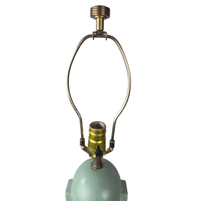 A captivating vintage mid-century table lamp in the atomic deco style, sculpted in plaster. Its tapered skyscraper column...