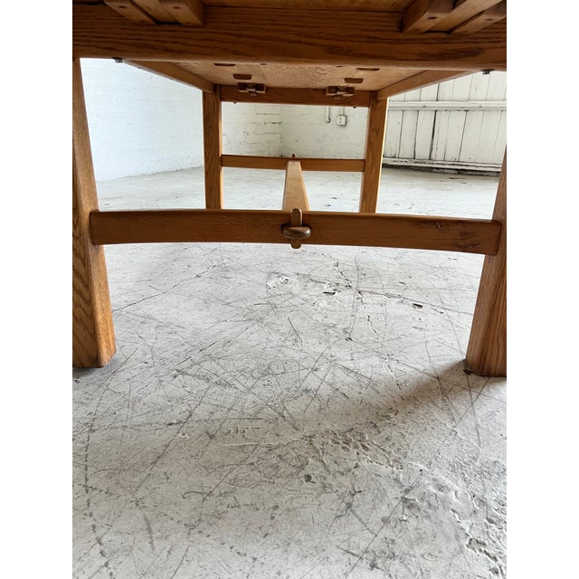 Very large studio craft oak dining table, featuring beautifully refinished grain on the large table top, hardware less...