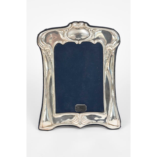 Sterling silver picture frame made by Ron Carr Ltd. Sheffield. The frame has an ornate scrolling foliage designs...