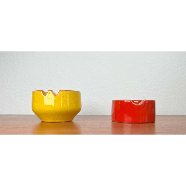Mid-Century Modern German Space Age Red and Yellow Ceramic Ashtrays, 1960s, Set of 2, in Very Good conditions. Designed...