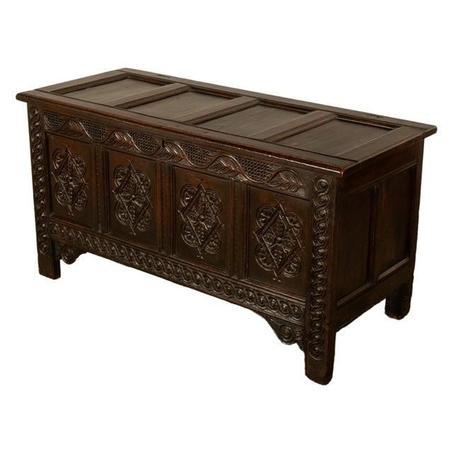 A fine antique English carved oak, 17th century coffer or chest, from the reign of King Charles II, circa 1660. The hinged...
