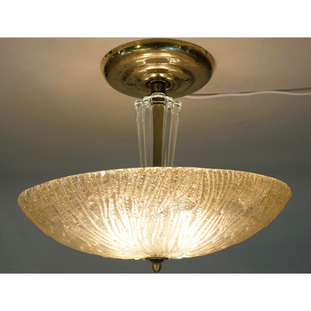 A dramatic and impressive Art Deco Modern Lalique Style Slag molded Saucer shaped form hanging ceiling lamp designed and...
