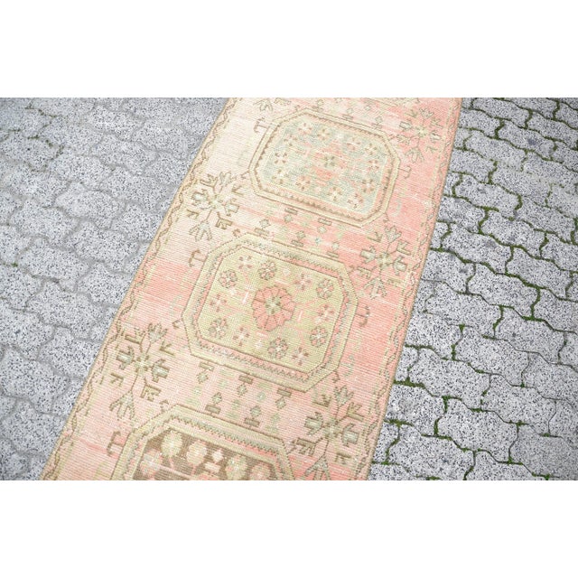 This is a vintage Turkish Oushak rug from the 1960s. The piece was hand-knotted.