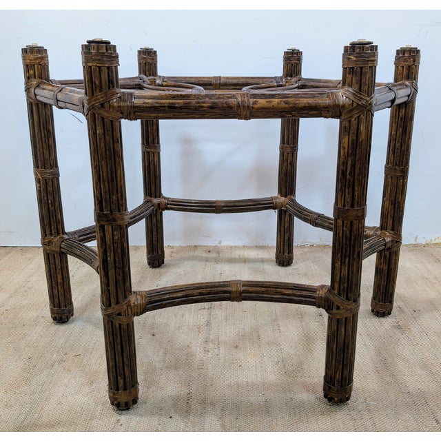 In the distinctive style of McGuire, this vintage table features a beautifully crafted handwoven rattan and faux bamboo...