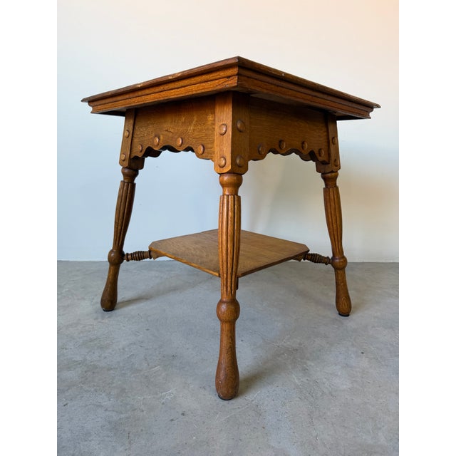 Beautiful antique French farmhouse accent table crafted from solid oak, showcasing warm natural wood grain and timeless...