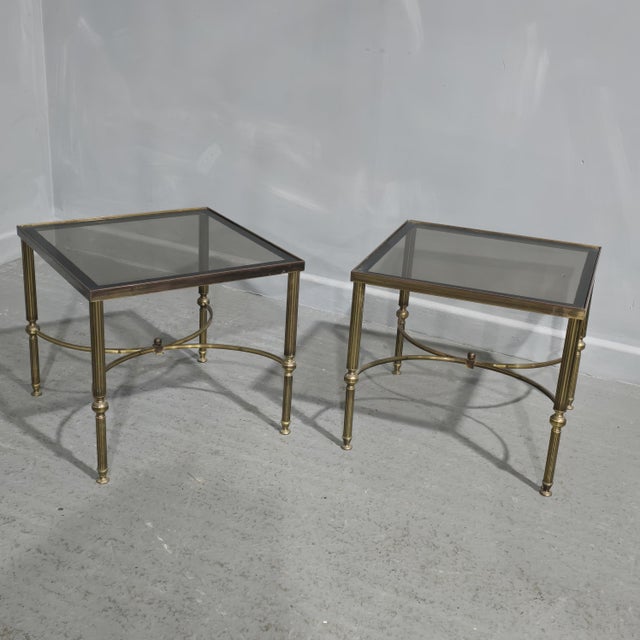 A very nice pair of French brass Maison Jansen style lamp tables with smoked glass tops, in overall very good condition....