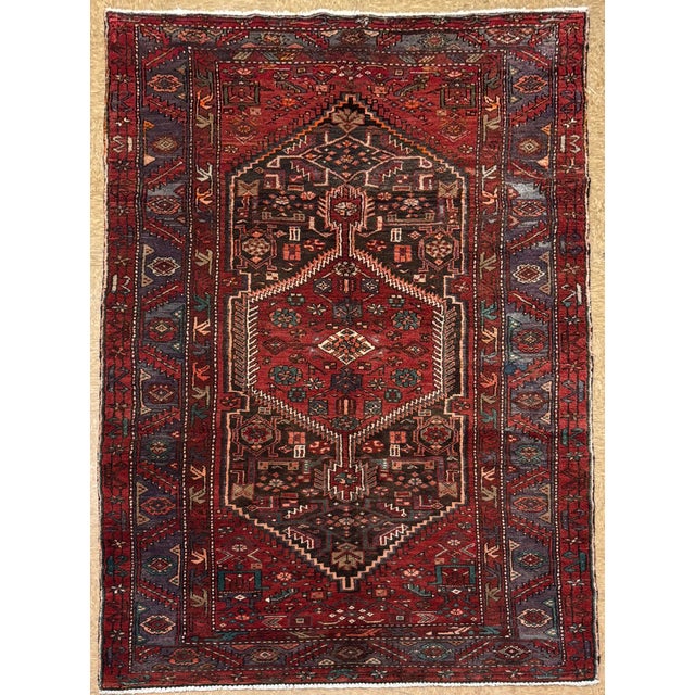 Antique hand-knotted runner from the Hamedan region of western Iran, featuring a bold geometric medallion design set on a...