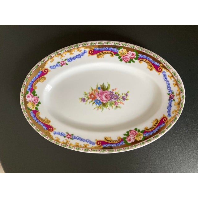 A beautiful French roses Limoges porcelain oval jewelry dish, circa mid 20th century, France, Europe. Piece showcases...