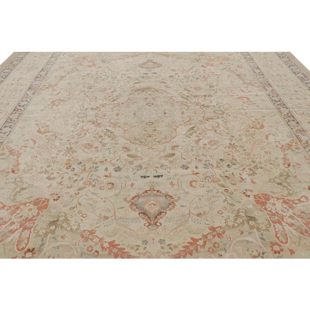 Hand-knotted in wool, this 12x15 modern rug with floral patterns is inspired by vintage and antique Persian rugs of Tabriz...