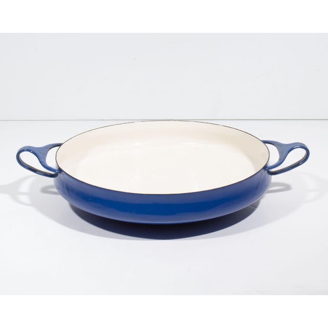 A blue enamel paella pan designed by the Danish designer Jens Quistgaard (1919-2008) for Dansk International Designs. This...
