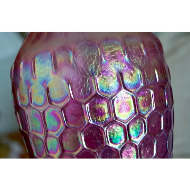 Striking handblown studio art glass vase by Josh Ries, featuring a luminous iridescent pink finish with an intricate...
