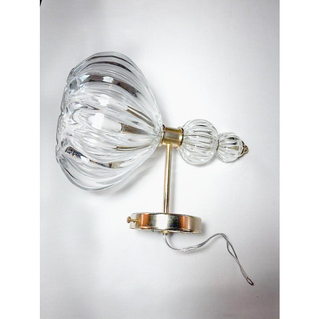 A stunning pair of Murano glass wall sconces accented with elegant brass details. As shown in the cover photo, they are...