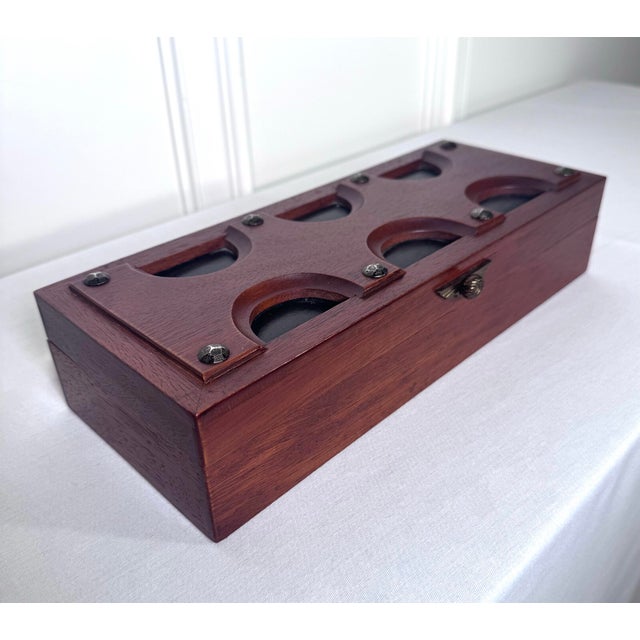 This vintage lidded box is a mid-century modern valet or jewelry box. It's crafted from rich, cherry-finished wood, it...