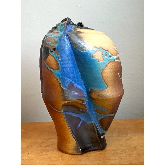 With its sculptural asymmetry and dynamic drip glaze, this vintage ceramic vase brings a strong Mid-Century Modern accent...