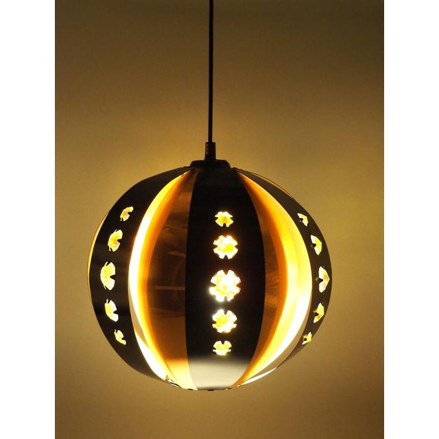 The lamp has a delightful colour combination of black and copper with clear plastic diamond shape inserts, allowing a...