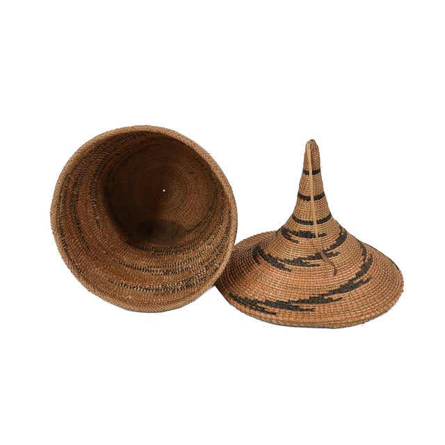 The Tutsi Tight Weave Basket with Lid from Rwanda epitomizes the artistry and tradition of the Tutsi community's weaving...