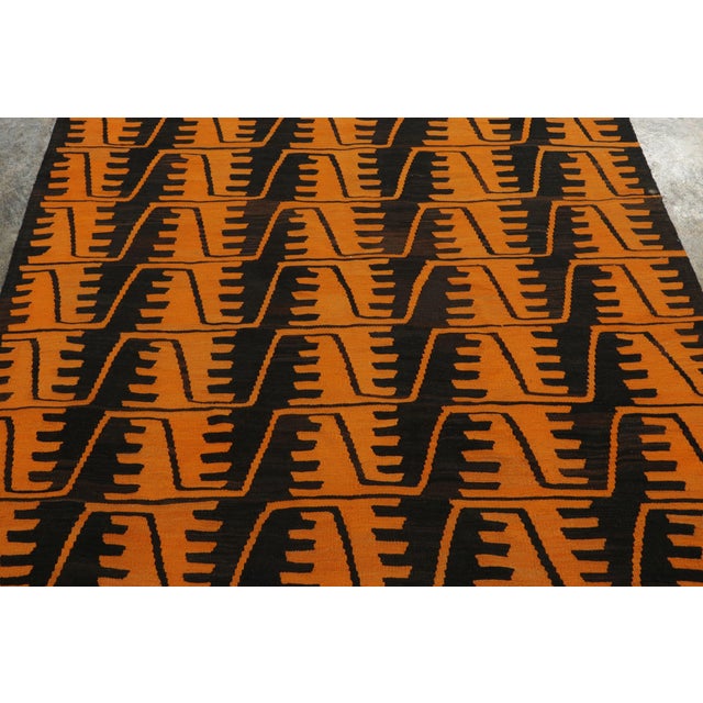 Made with handwoven wool in Turkey circa 1950-1960, this vintage 9x15 kilim with a minimalist geometric pattern is a...