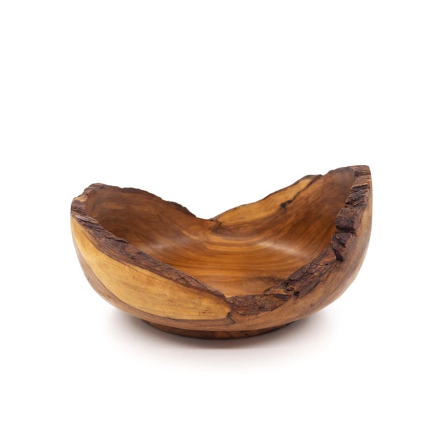 A beautifully hand-carved olive wood bowl, handmade in Peru and finished with a natural live edge that highlights the...