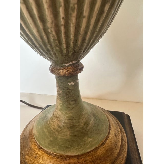 Beautiful pair of celadon green carved wood lamps having gilded highlights and neoclassical urn shape. 7.25” W x 6” D...