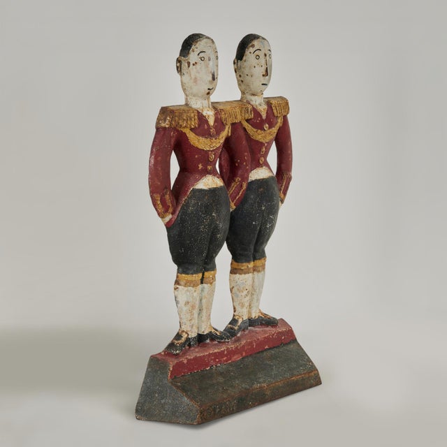 Transporting cast iron double footmen in service as a doorstop with the original paint now worn to perfection. Signed FISH...