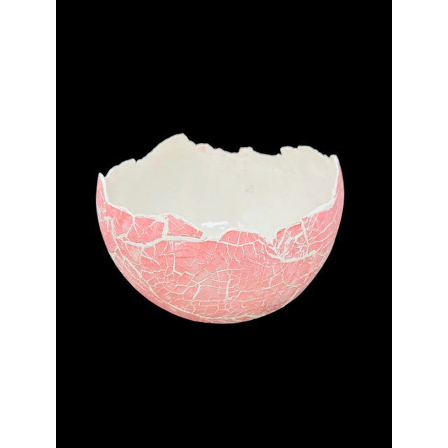 Measuring approximately L 10.25" W 10.25" H 7.5" This stunning ceramic dinosaur egg is a one-of-a-kind creation by the...