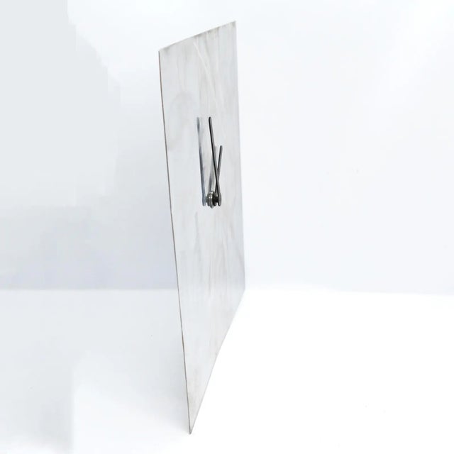 80's German wall clock made of a single sheet of brushed stainless steel. In very good vintage condition, with normal...