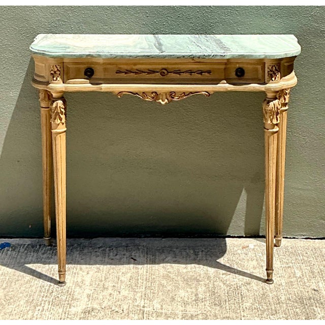 Exuding classical European charm and Neoclassical elegance, this vintage console table features an exquisite contoured...