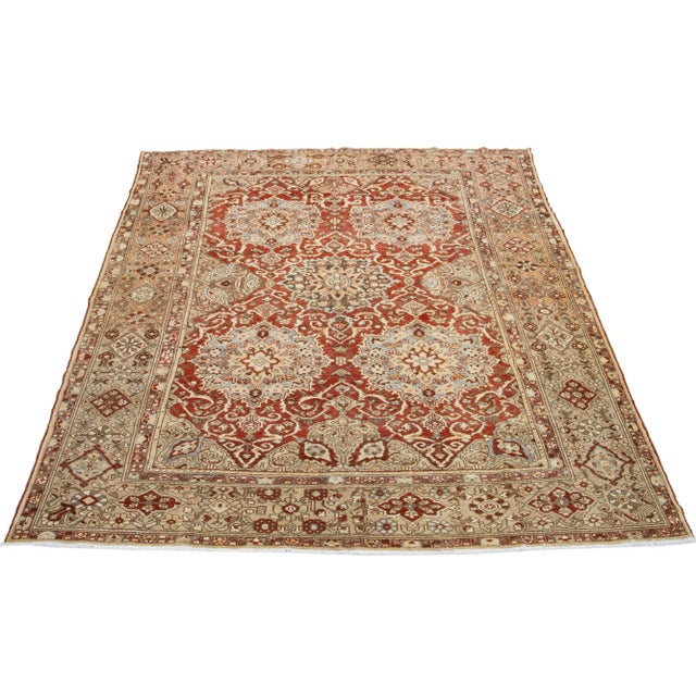 Beautiful Antique Bakhtiari hand-knotted wool rug with a red-rust color field. This Persian piece has blue, beige, and...