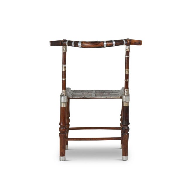 Chair with hammered metal decor. Curved backrest. Folk art. African or Indian work realized at the beginning of the 20th...