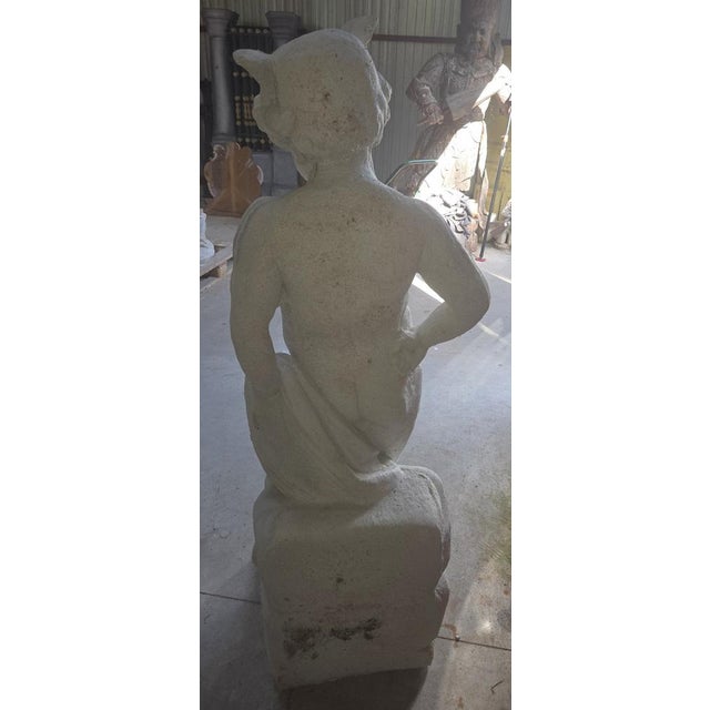 Reconstituted Stone Garden Statue of a Young Faun – 20th Century An elegant reconstituted stone garden statue of a young...