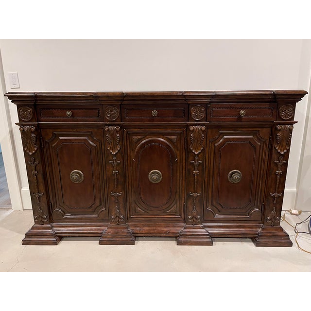 Mahogany Maitland Smith Sideboard in excellent used condition. Shelving in each of the bottoms doors. Serveware liner in...