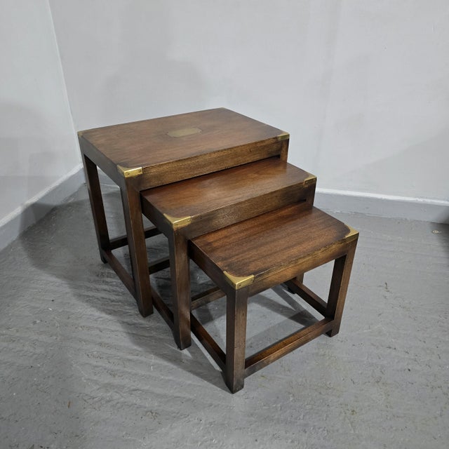 Very nice campaign nest of three tables, in overall very good colour and condition, inset corners and central brass...