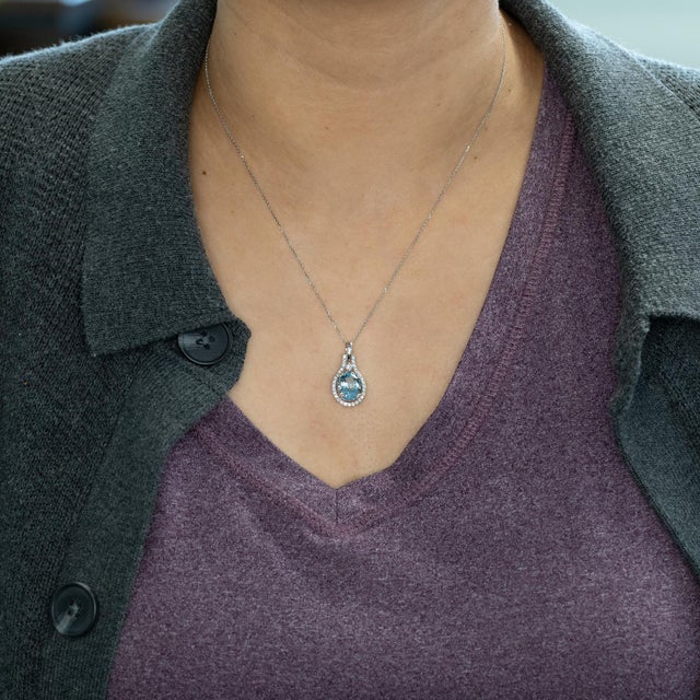 A luminous 3.5Ct oval aquamarine (11x9mm) set in solid 14K gold, accented with natural earth-mined diamonds for radiant...