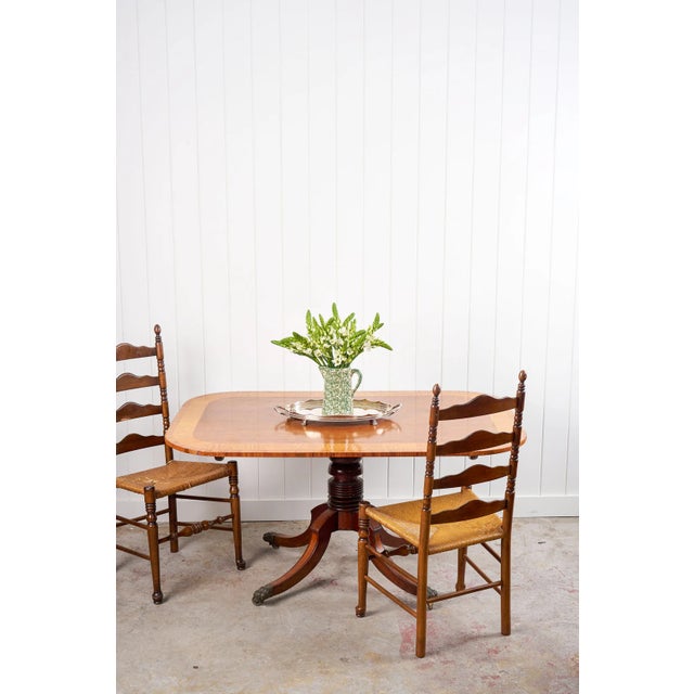 This George III walnut breakfast table features a beautifully figured top with satinwood banding, offering a rich contrast...
