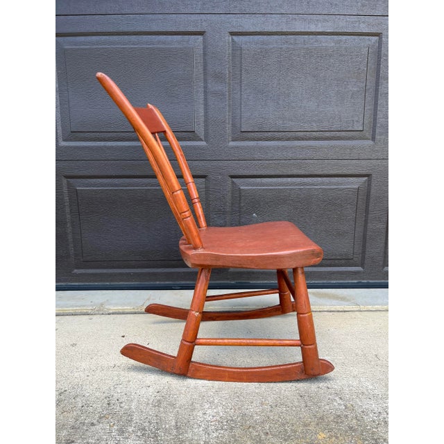 Earlier piece from the mid 1800s with spindle bent back, plank bottom, handmade square nails, and wooden pegs in construction