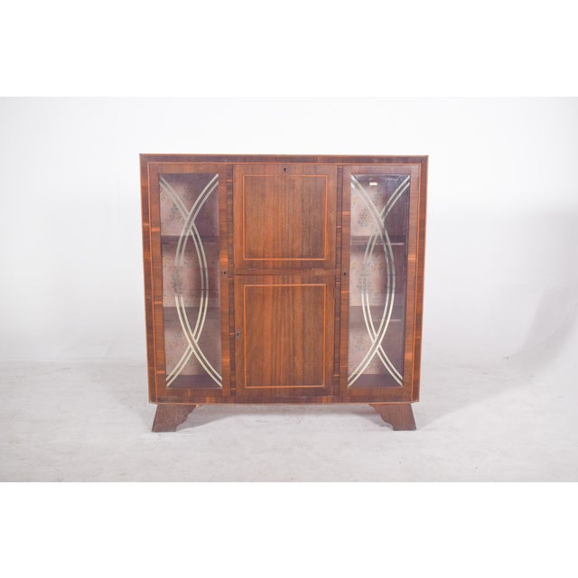 Rosewood display case. The piece has straight, well-defined shapes, with geometric details that add beauty and elegance to...
