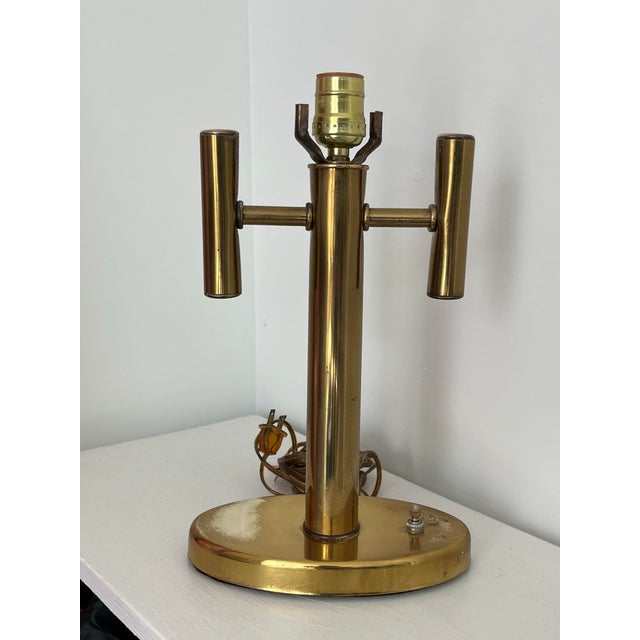 A sweet petite 1970s brass cylinder lamp with a dual arm candelabra design. Perfect for small bedside table, or bath. In...