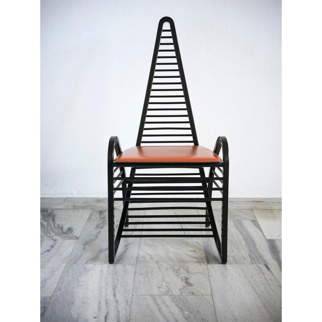 High back chair with curved lines in black lacquered wood and cognac leather seat.Designed by Antonio Sibau, Italy 1980s