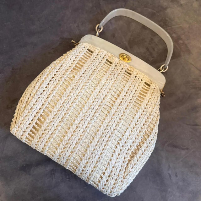 This exquisite 1950s Italian handbag is a prime example of mid-century resort elegance, combining artisanal texture with...