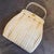 This exquisite 1950s Italian handbag is a prime example of mid-century resort elegance, combining artisanal texture with...