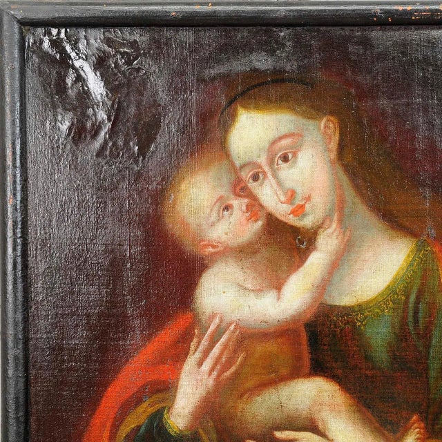An antique oil painting depicting the holy Mother with Child named the Miraculous Image of Innsbruck. Oil on canvas with...