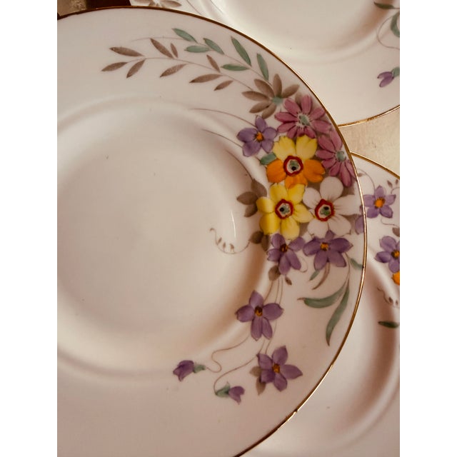 A delicate and cheerful set of five vintage dessert plates by Tuscan China, England. Each plate features soft lavender...